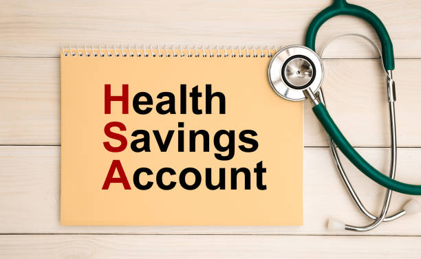Notepad with text Health Savings Account HSA and stethoscope. stock photo