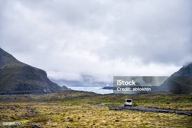 Landscape View On Skaftafell National Park Iceland Glacier Tongues With Tour Van On Gravel Road And Mist Fog Clouds In Mountains Stock Photo - Download Image Now