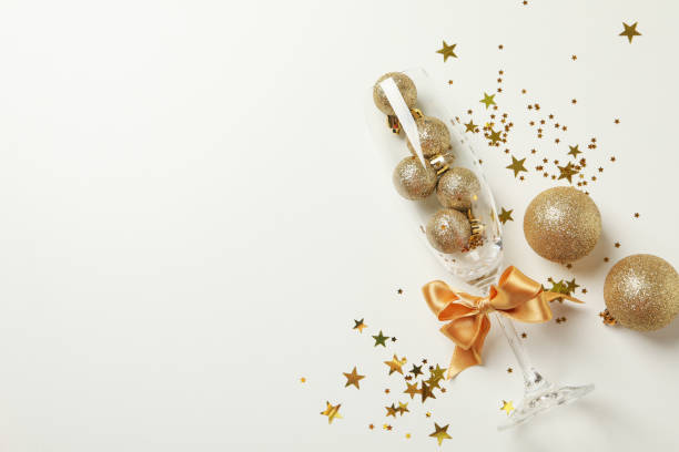 istock Champagne glass, glitter and baubles on white background 1283892773