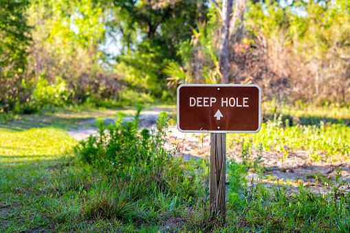Sign closeup to Deep hole sinkhole hiking trail and nobody at Myakka River state park in Sarasota Florida