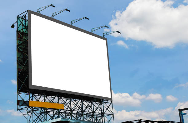 istock blank canvas billboard white screen design for display advertising banner outdoor. large mockup ad banner with blue sky and cloud. 1283893571