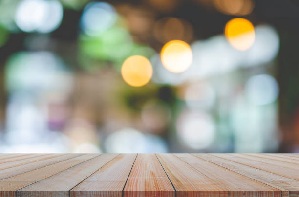 istock wooden table with abstract blurred background resturant lights used for display montage products mock up design. 1283893639
