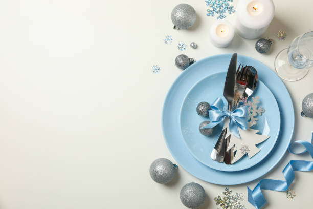 istock Concept of New year table setting with decorative snowflakes on white background 1283893667