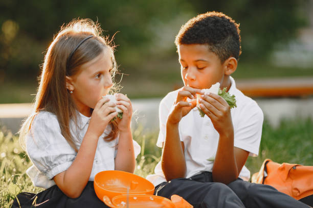 istock Little african boy take a breakfast with caucasian girl 1283894341