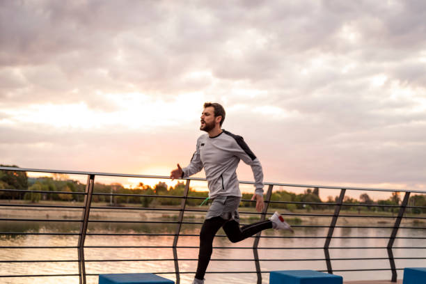 istock A Young Man Running on the Bridge Along a River. Confidence Goes a Long Way. 1283895111