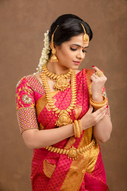 Beautiful Indian young Hindu Bride Beautiful Indian young Hindu Bride against brown background in studio shot traditional clothing photos stock pictures, royalty-free photos & images