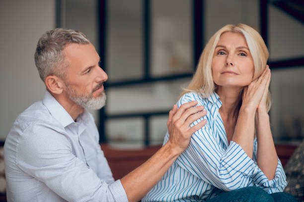 istock Man and woman sitting on the sofa and looking thoughtful 1283895427