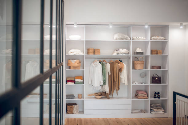 istock White wardrobe with clothes and shoes on the shelves 1283896110