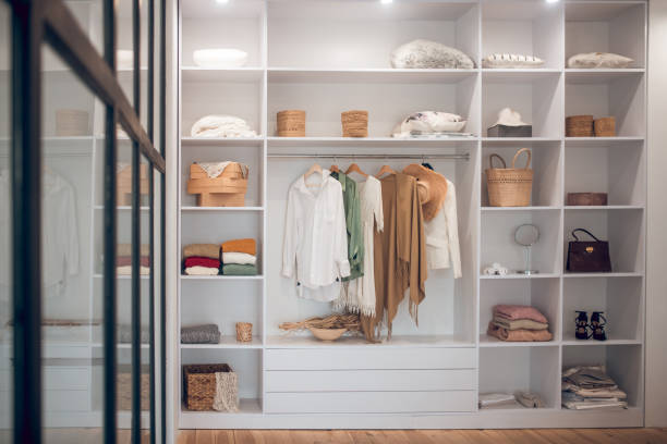 istock White wardrobe with clothes and shoes on the shelves 1283896112