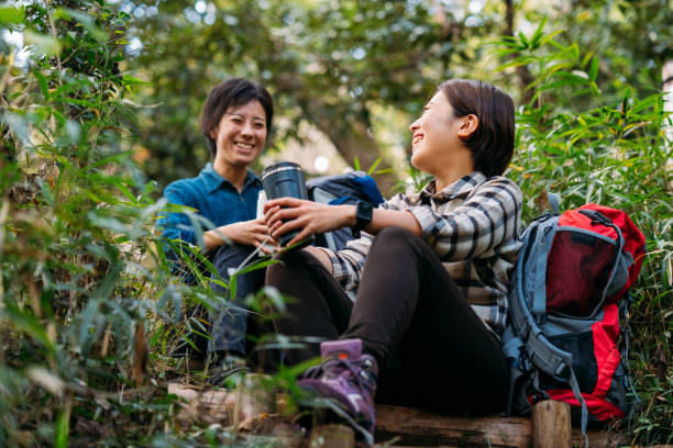 istock Two female friends taking break and talking in nature during hiking 1283896152