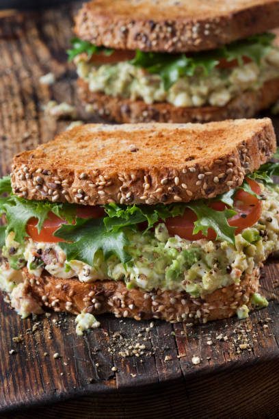 istock Avocado and Egg Salad Sandwich with Crispy Bacon, Lettuce and Tomato 1283896282
