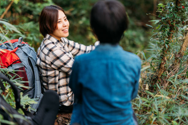 istock Two female friends taking break and talking in nature during hiking 1283896487