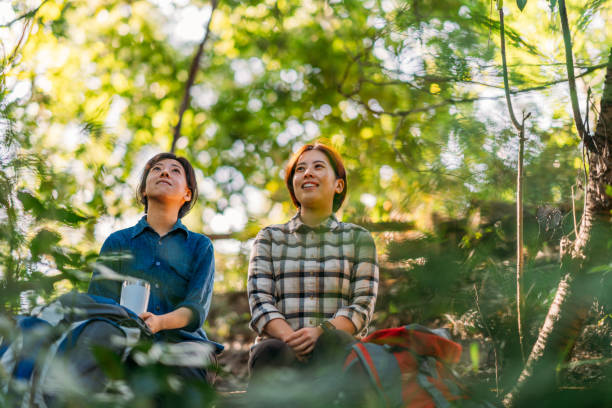 istock Two female friends taking break and talking in nature during hiking 1283896726