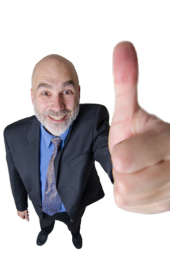 Business man with thumbs up on white background.\nTaken with super wide angle lens and directly above. This distorts the proportions and gives a big head to the man.