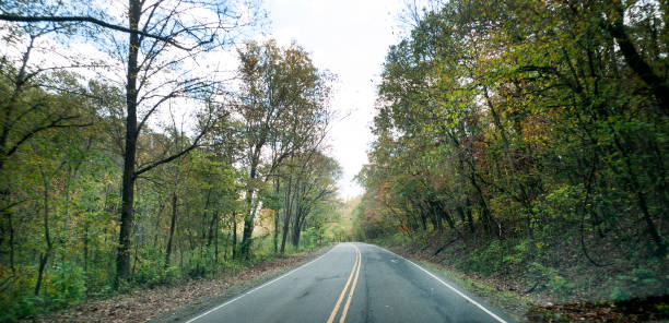 istock Curvy country road in autumn 1283898590