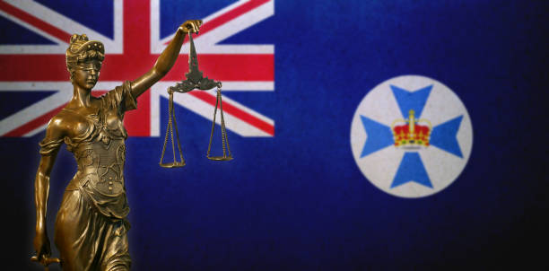 istock Lady Justice before a flag of Queensland 1283899332