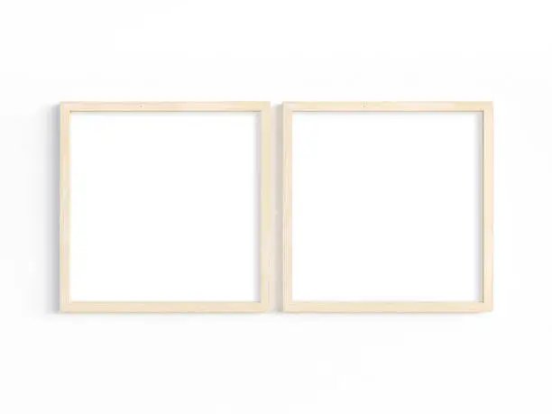 Two square wooden frames on a light wall. Mockup of 2 frames to display your artwork. 3D illustration.