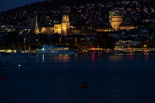 Zurich city Switzerland late evening blue hour hills in the background lake side view.