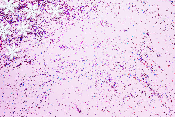 istock White snowflakes and pink sequins are scattered on a pink background, flat layout, copy space. New year's background or greeting card. Christmas concept 1283899790