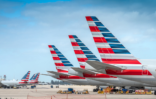 Miami, USA - November 4, 2020: America Airlines planes waiting for passengers at Miami International Airport.