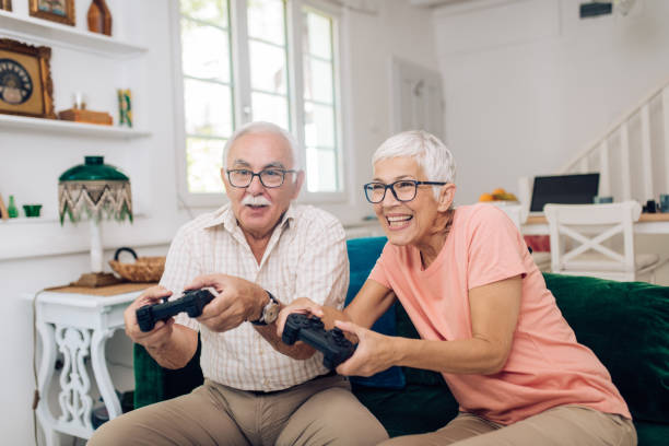 istock Excited senior couple gaming at home 1283901058