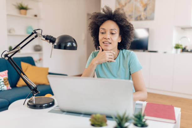 istock Beautiful Afro woman working online from home 1283901317