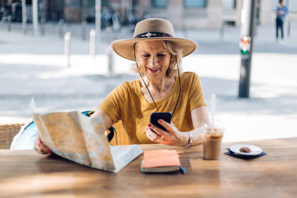 istock Senior tourist taking a coffee break and using smartphone 1283901416