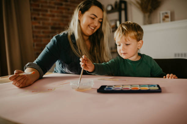 istock Mother paints with her son 1283902225