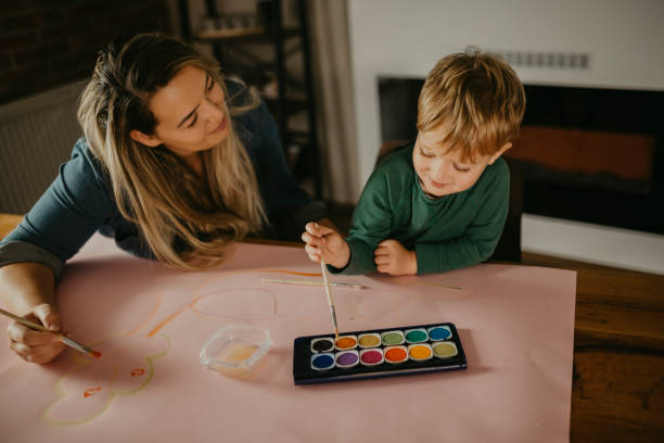 istock Mother paints with her son 1283902272