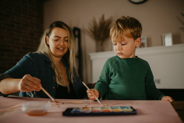 istock Mother paints with her son 1283902310