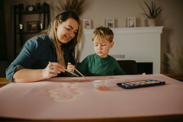 istock Mother paints with her son 1283902630