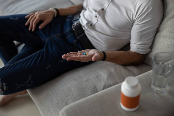 istock Person with a few pills on his palm 1283903540
