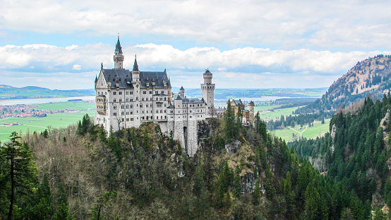 Fussen, Germany- October 25, 2023: Neuschwanstein Castle is a 19th-century historicist palace on a rugged hill of the foothills of the Alps in the very south of Germany.