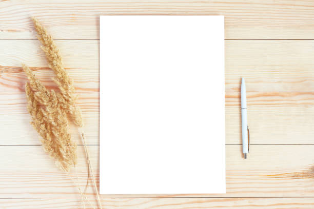 istock Blank sheet of paper mockup on light wooden background 1283903992