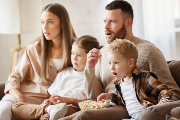 istock Shocked family with popcorn watching film 1283906016