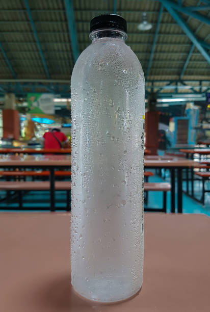 water droplets sticking to the plastic bottle on the table. Selective focus