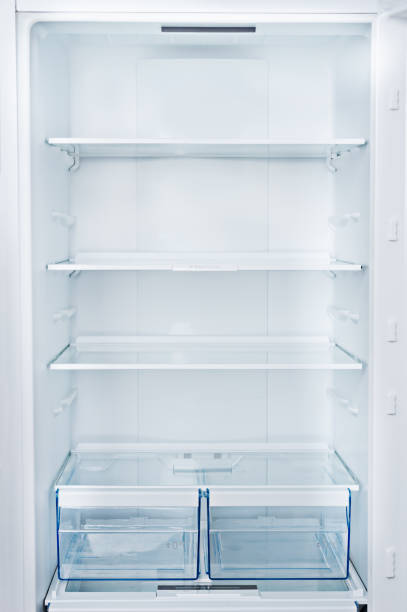 empty fridge Empty Refrigerator with door open. Vertical photo and copy space fridge light stock pictures, royalty-free photos & images