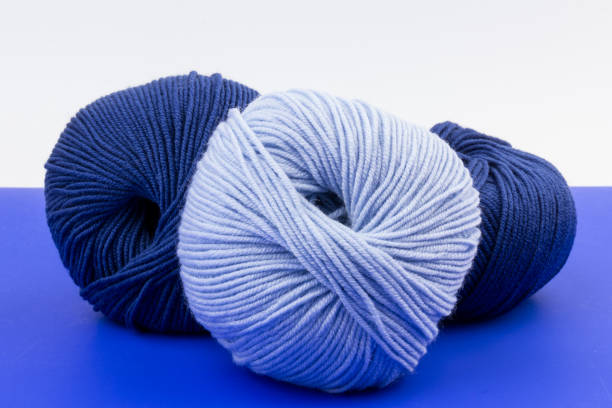 istock woolen merinos blue threads on blue and white background. natural wool. knitting. background 1283908477