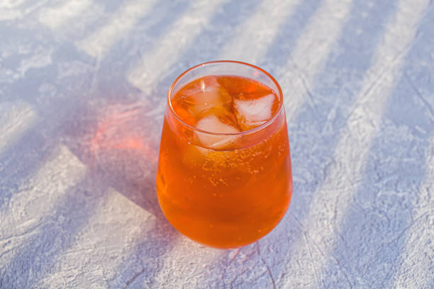 Italian Spritz alcohol cocktail with ice cubes. Summer refreshing orange drink with bitter, sparkling wine prosecco and soda. Copy space for text