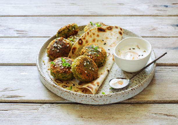 Falafel patties, flat bread and yogurt sauce stock photo