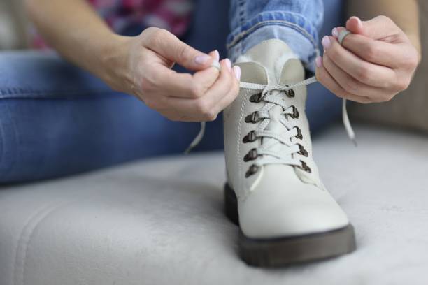 istock Light colored shoe on which lace is tied. 1283911058