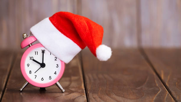 istock Alarm clock with santa hat, web banner 1283912300