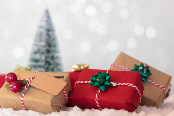 istock Wrapped christmas presents with pine tree on the background 1283912546