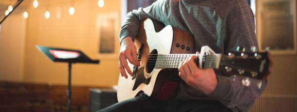 istock Young man playing on acoustic guitar 1283912716