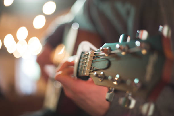istock Young man playing on acoustic guitar 1283912787