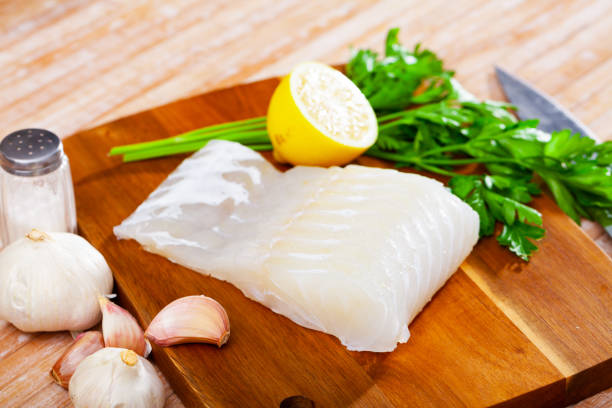 istock Raw fillet of pink cusk-eel with condiments 1283912958