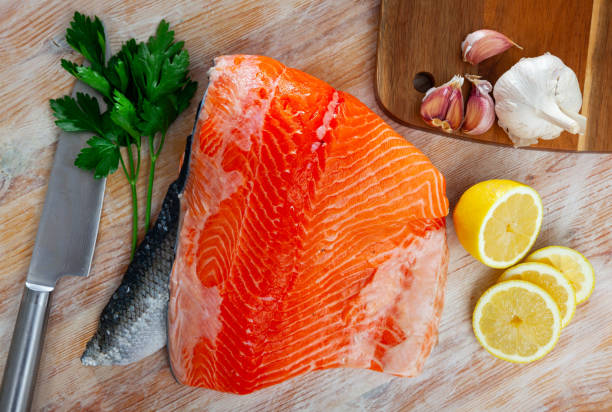 istock Uncooked fillet salmon fish with parsley and garlic 1283912992
