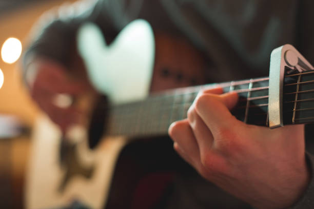 istock Young man playing on acoustic guitar 1283913696
