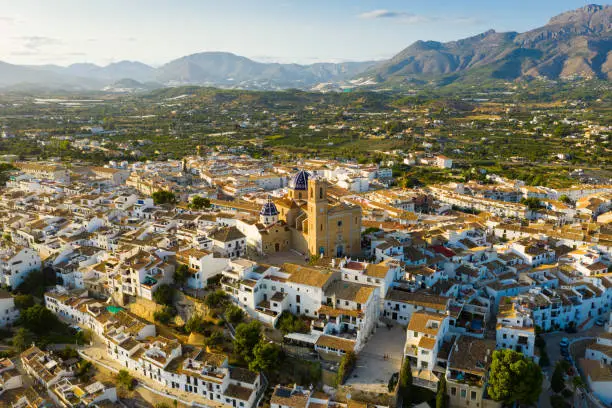 Panoramic aerial view of Altea city by Mediterranean coast overlooking blue and white domes of Church of Our Lady of Solace, Spain