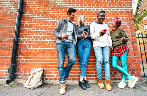 istock Multicultural hipster friends sharing content on smartphone at urban area in Shoreditch London - Millenial people and addictive fun with mobile smart phone - Technology concept on bright vivid filter 1283915465